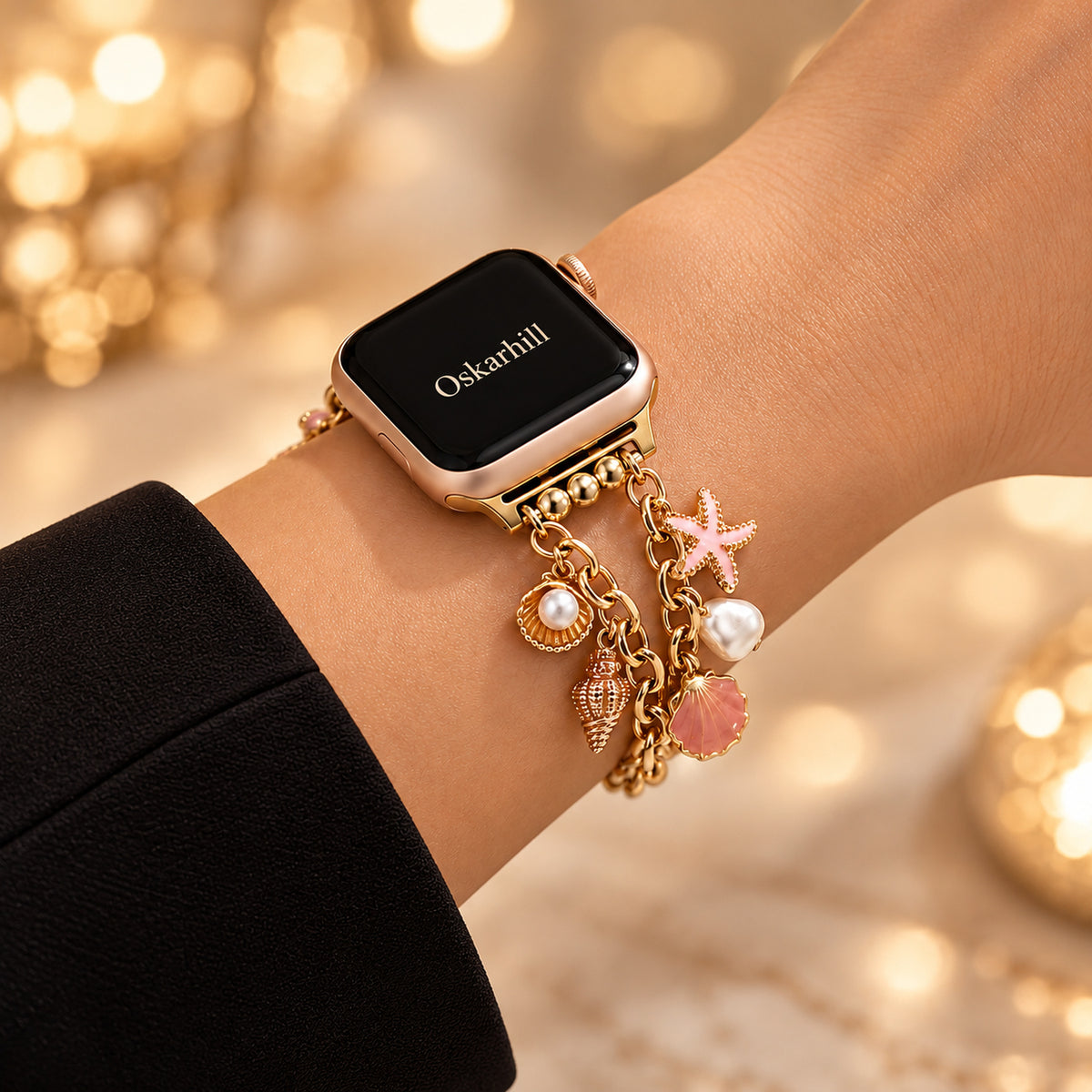 Mariselle gold-tone ocean charm Apple Watch bracelet styled with a black sleeve