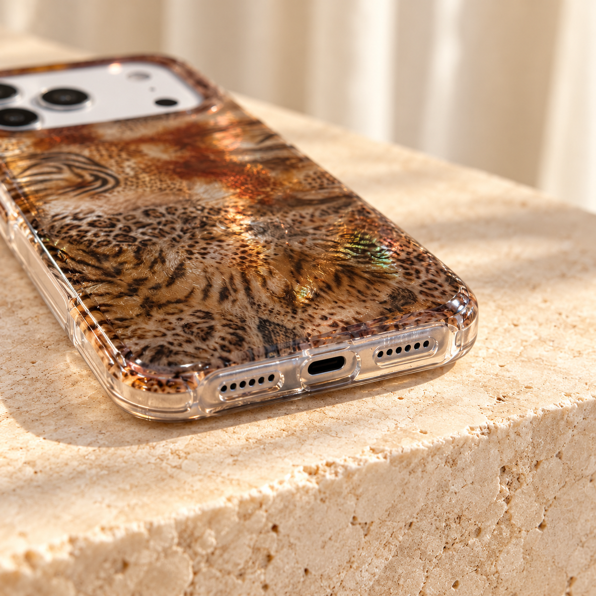 Bottom opening and clear-edge detail of the Animal Mix Amber Shimmer iPhone case.