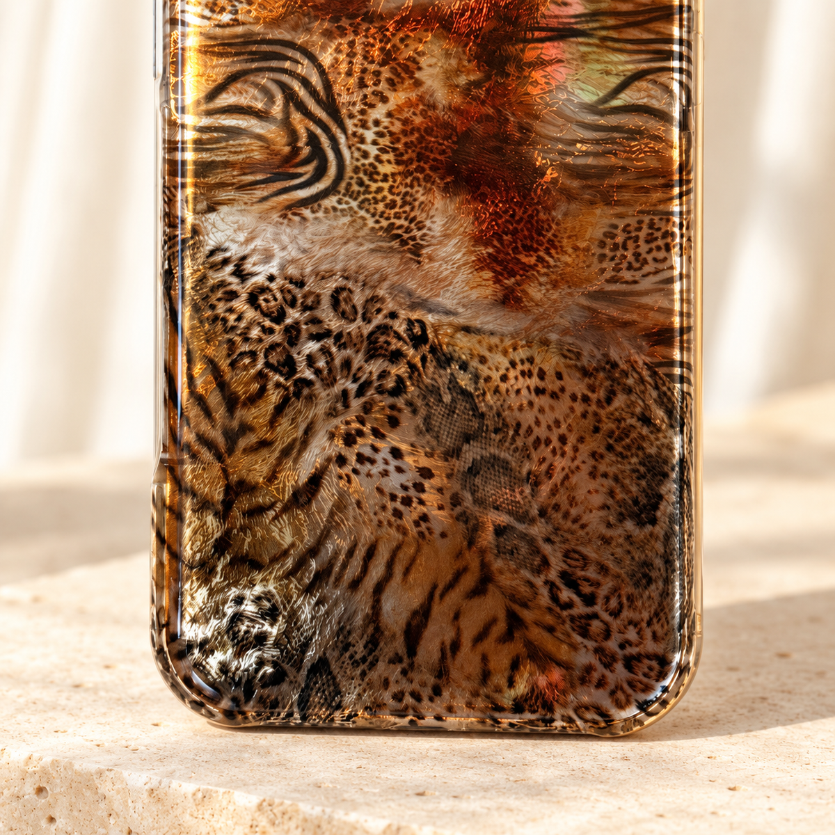 Close-up of the lower Animal Mix pattern on the Amber Shimmer iPhone case.