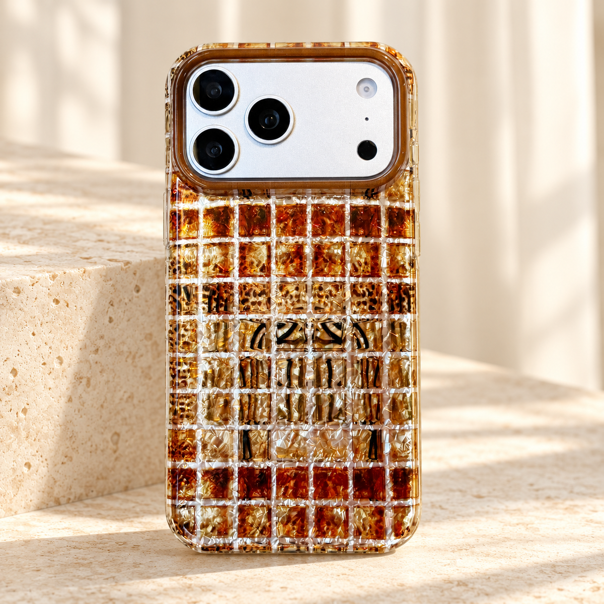 Amber Shimmer iPhone case in Plaid showing its pale grid and golden-brown design.