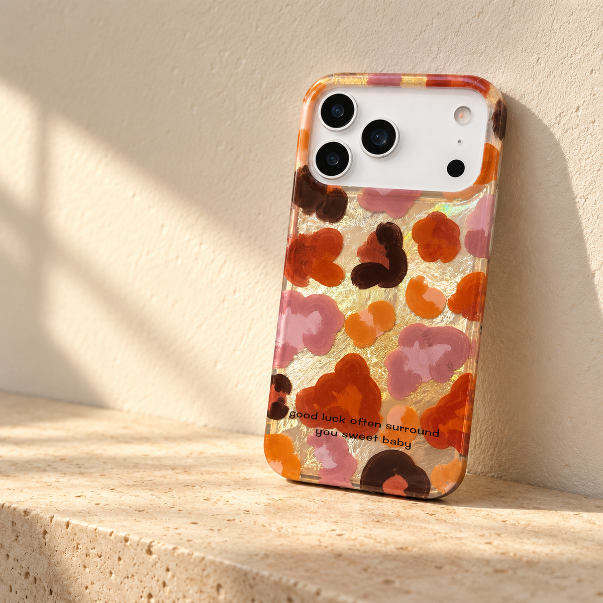 Autumn Mix floral case displayed on a pale limestone shelf in warm afternoon light.
