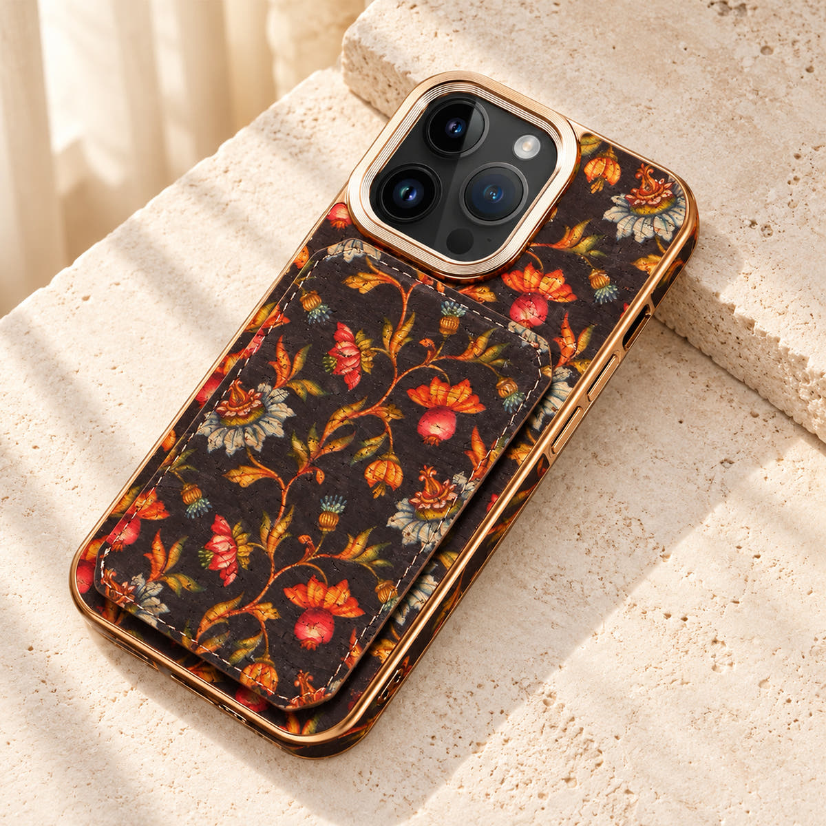 Bohemian gold-trim iPhone card holder case in Design #6 showing the printed wallet panel and gold-tone frame on cream limestone