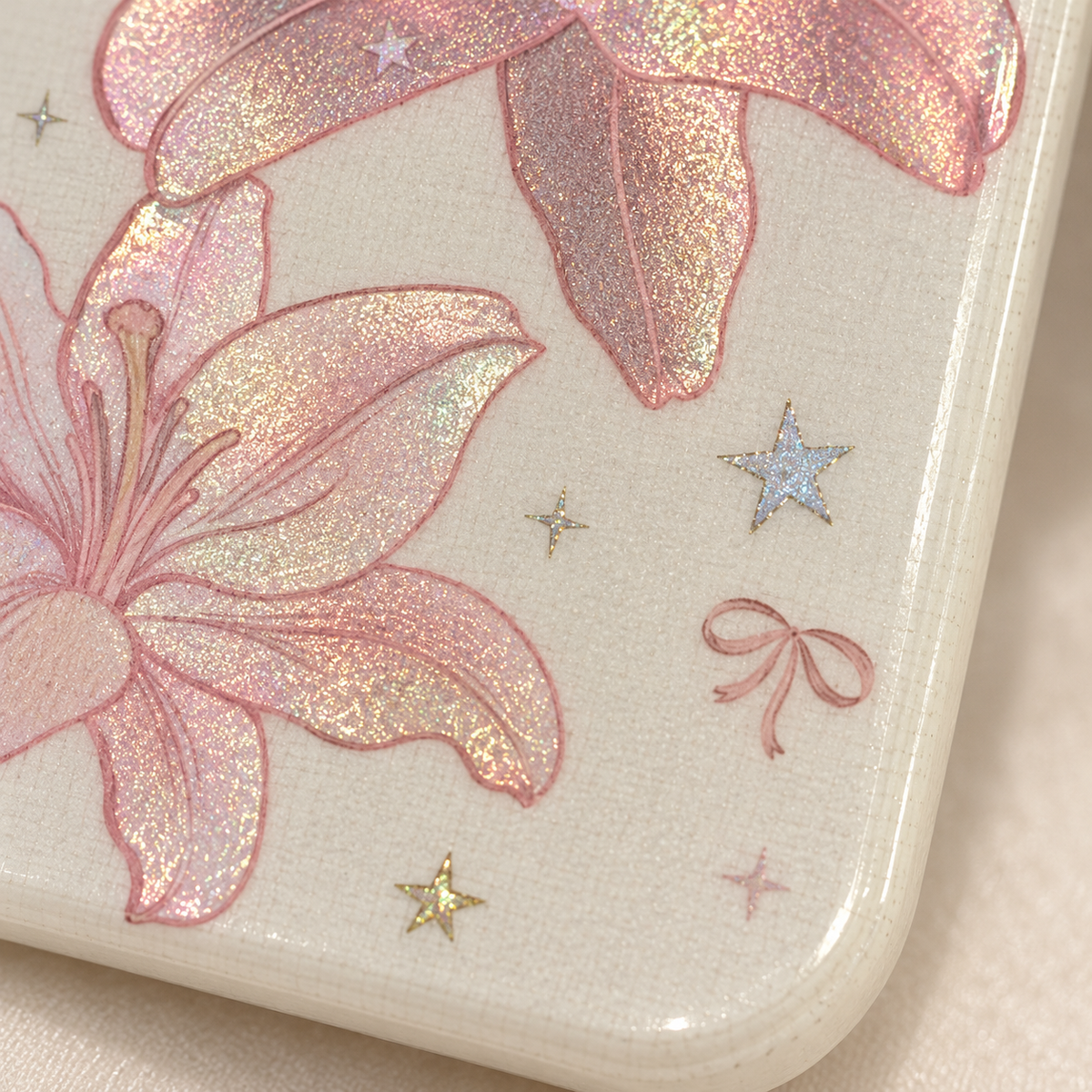 Delicate bow and small star accents beside the lower lily.