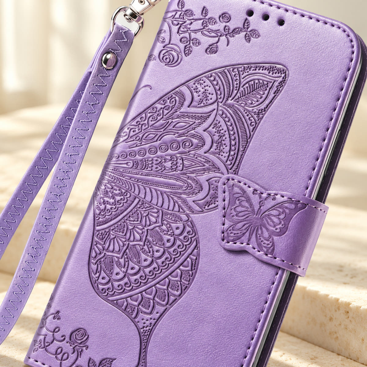 Close-up of the Lavender Butterfly wallet phone case showing the intricate embossed wing, small butterfly tab and stitched edge.