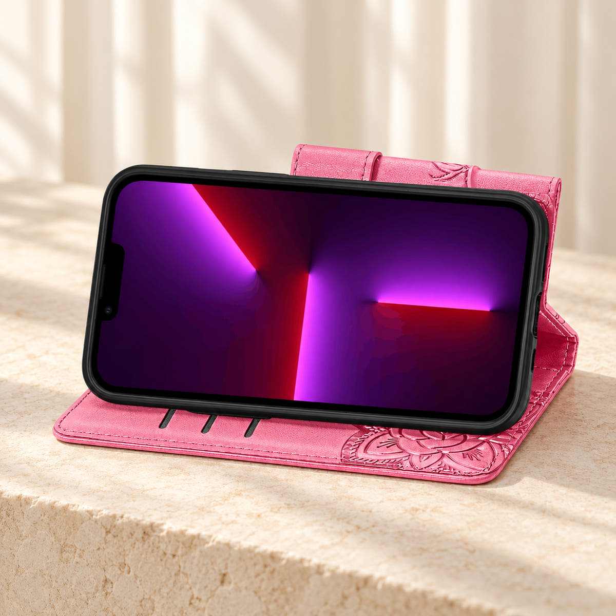 Butterfly iPhone wallet case in Pink folded into its landscape stand, with the original interior card-slot edges visible.