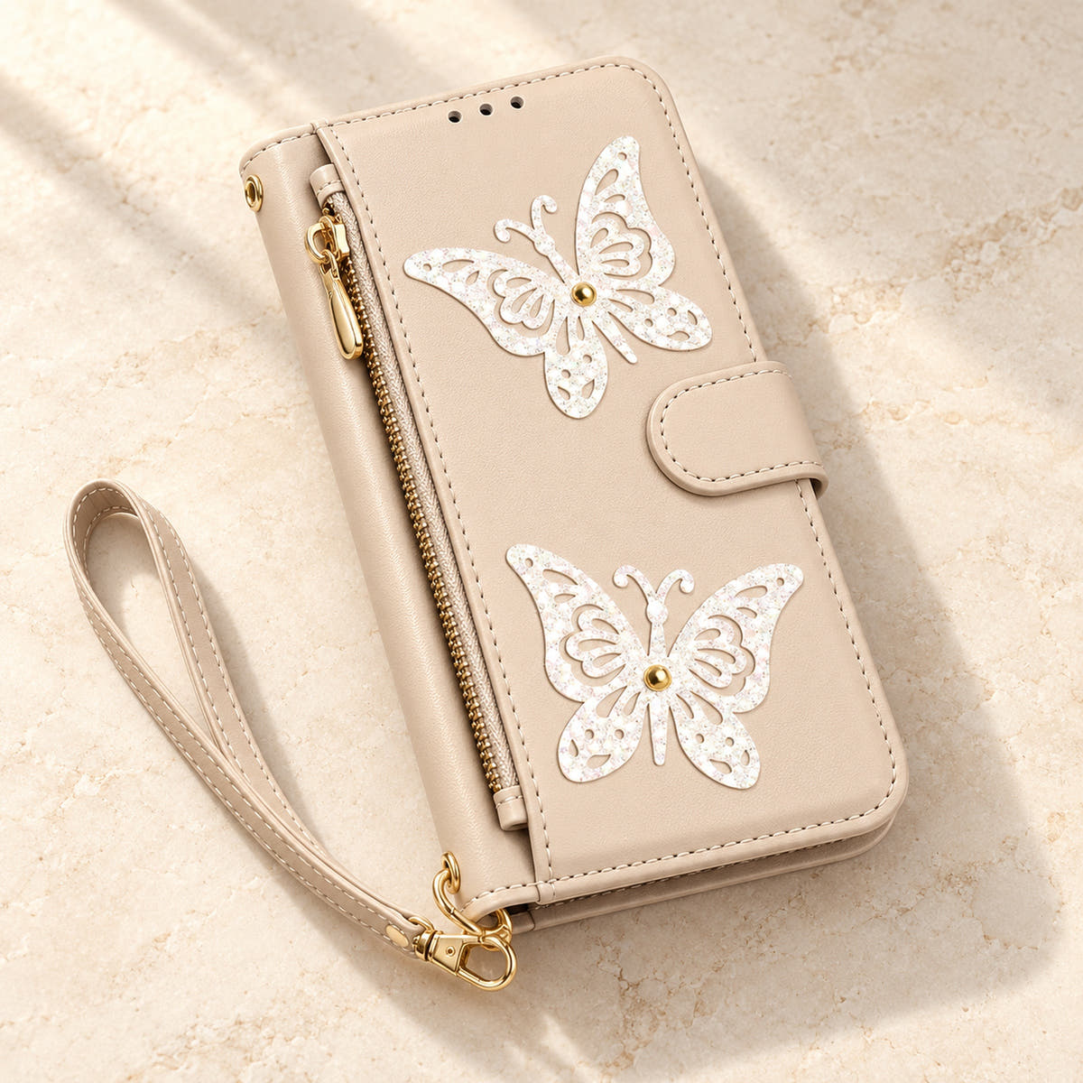 Beige Butterfly iPhone wallet case — closed cover and zip pocket on a tabletop