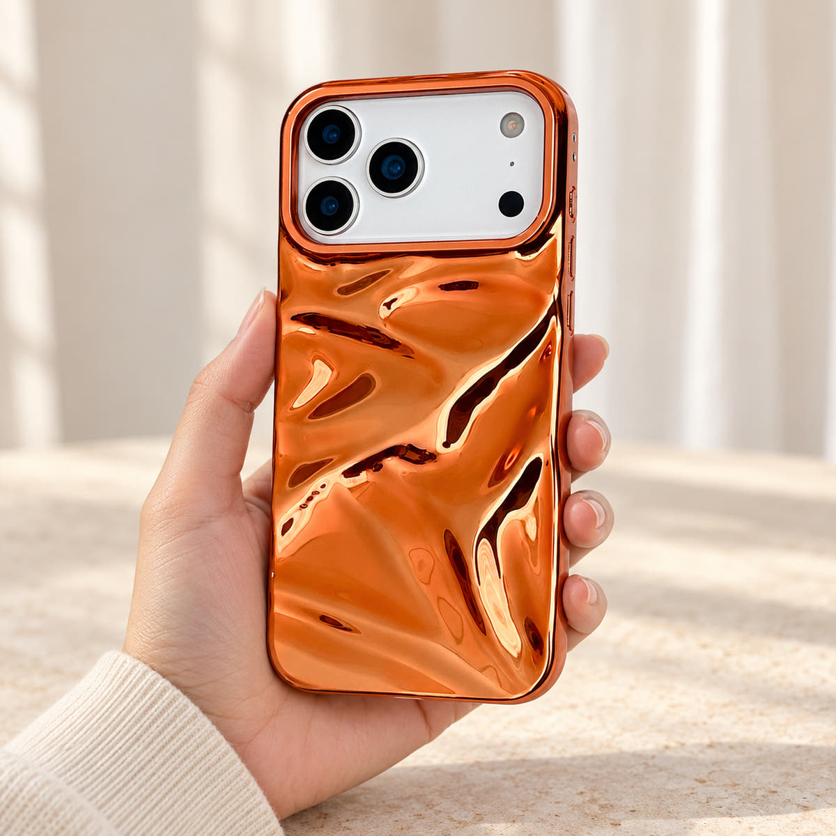 Copper-orange Chrome Wave iPhone case — handheld scale view
