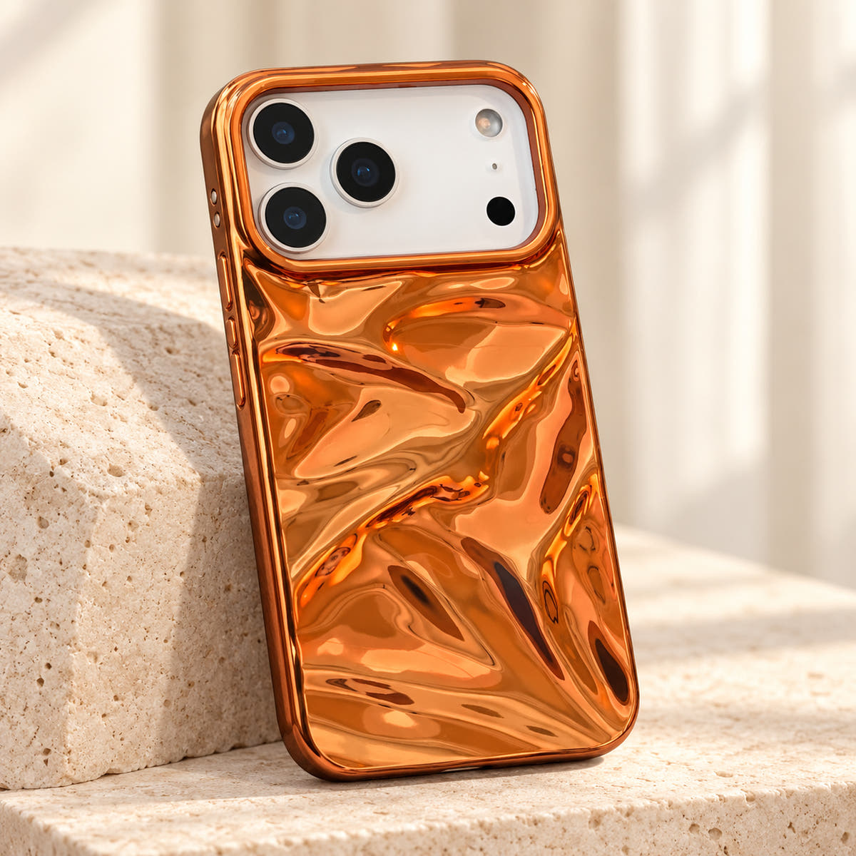 Copper-orange Chrome Wave iPhone case — tabletop diagonal view