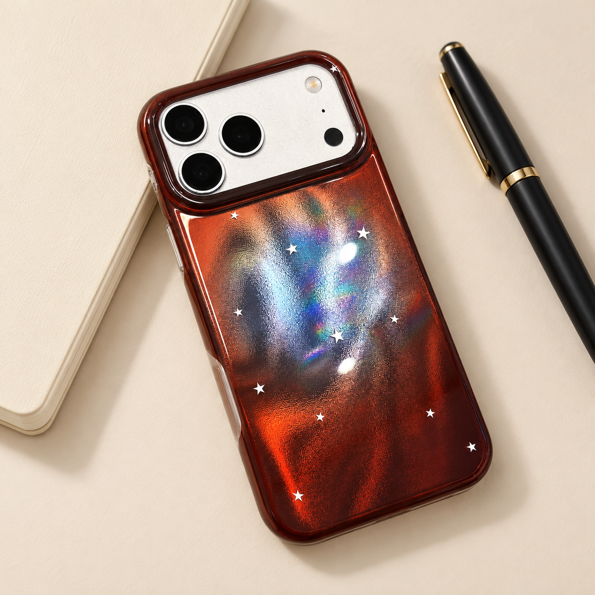 Copper Nebula Star case styled beside a plain notebook and pen.