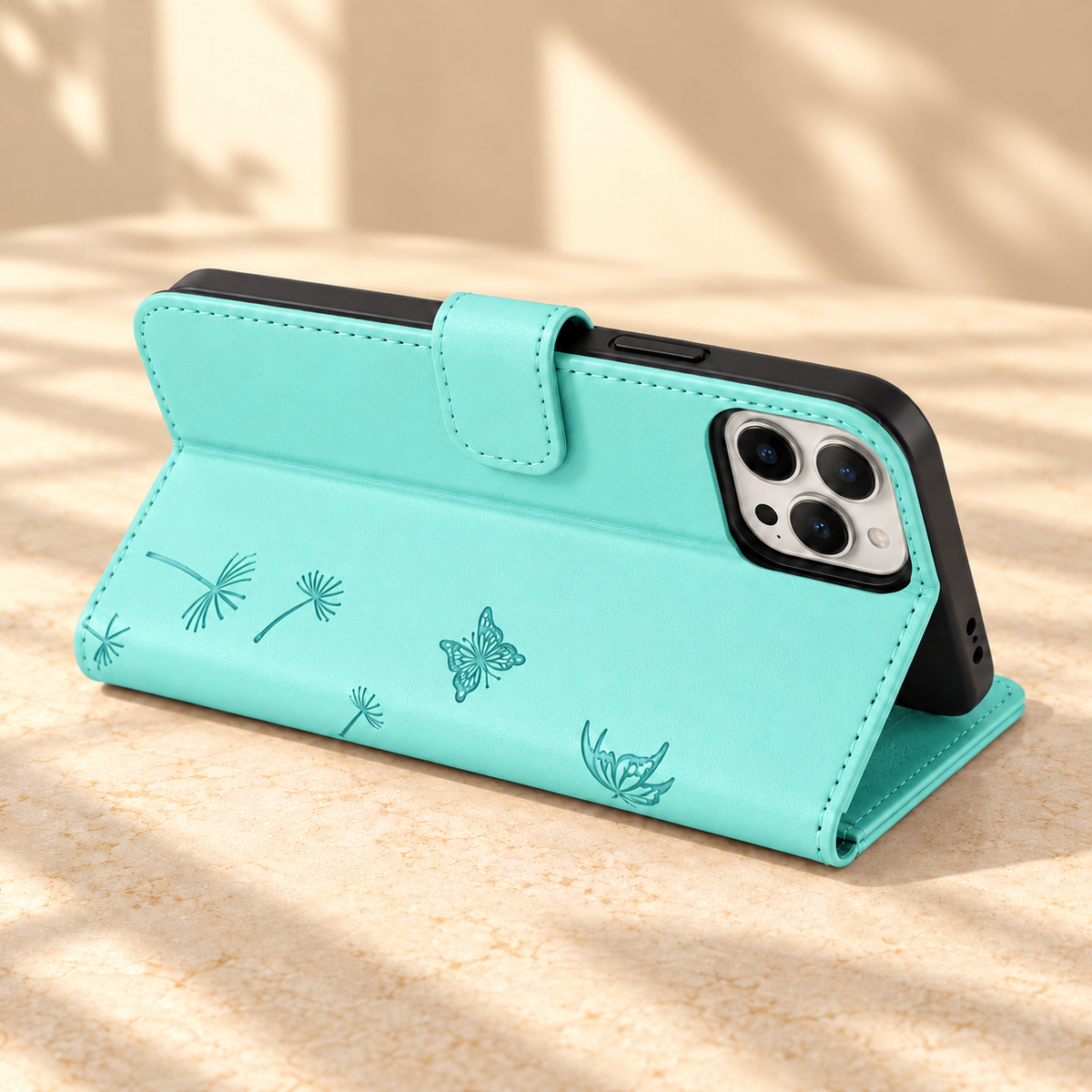 Mint Dandelion and Butterfly wallet phone case folded into a landscape viewing stand.