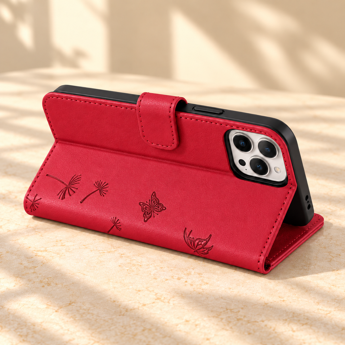 Red Dandelion and Butterfly wallet phone case folded into a landscape viewing stand.