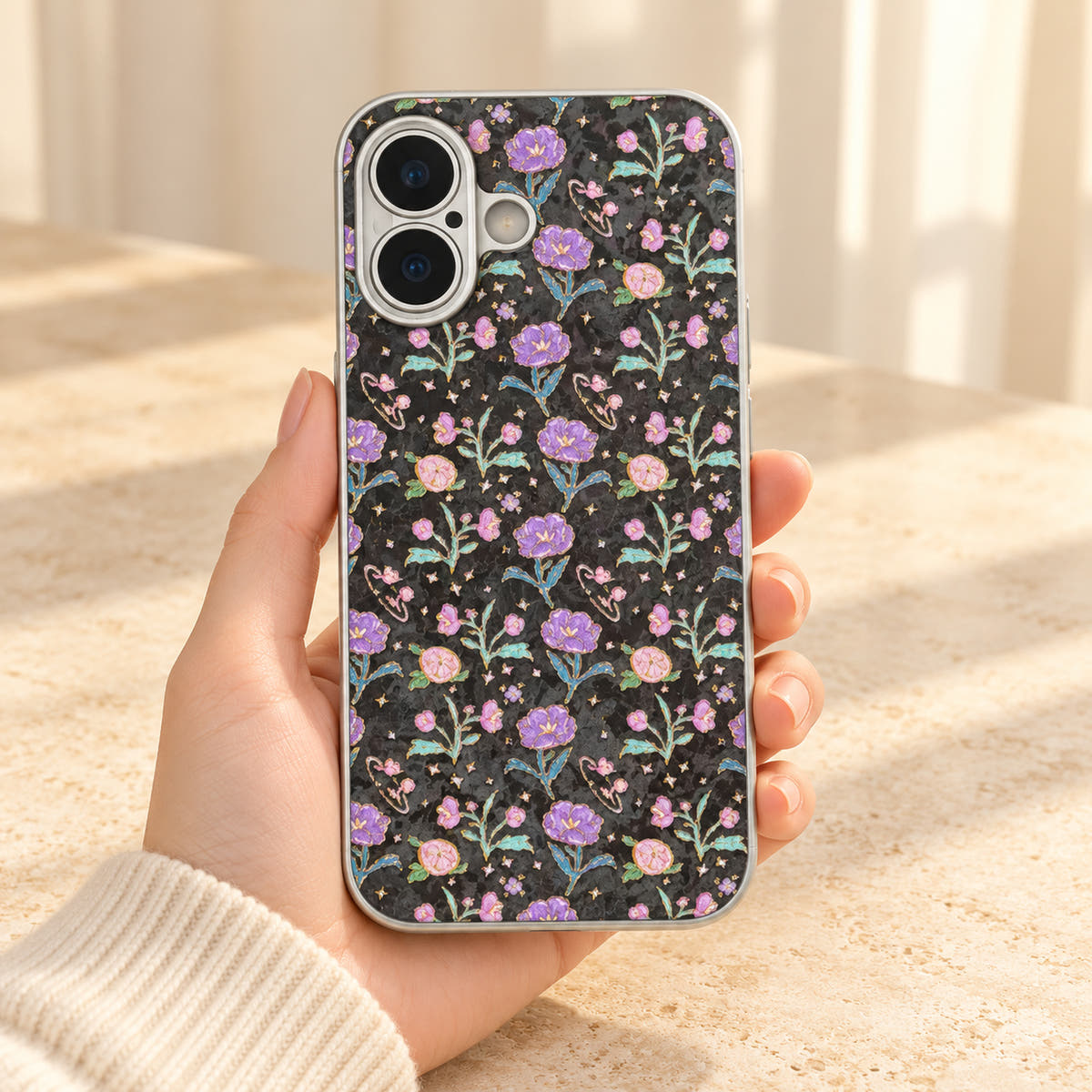 Black Elysia Floral case held with the wallet removed, revealing the complete floral print across the back.