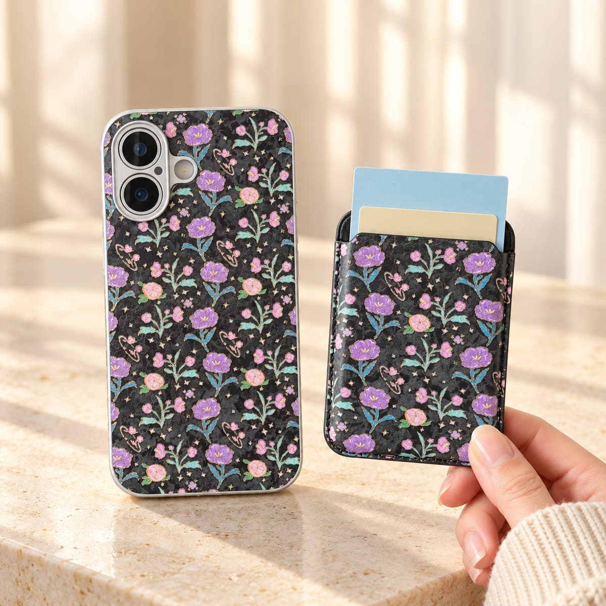 Black Elysia Floral case beside its detached matching card wallet, showing the floral design on both pieces.