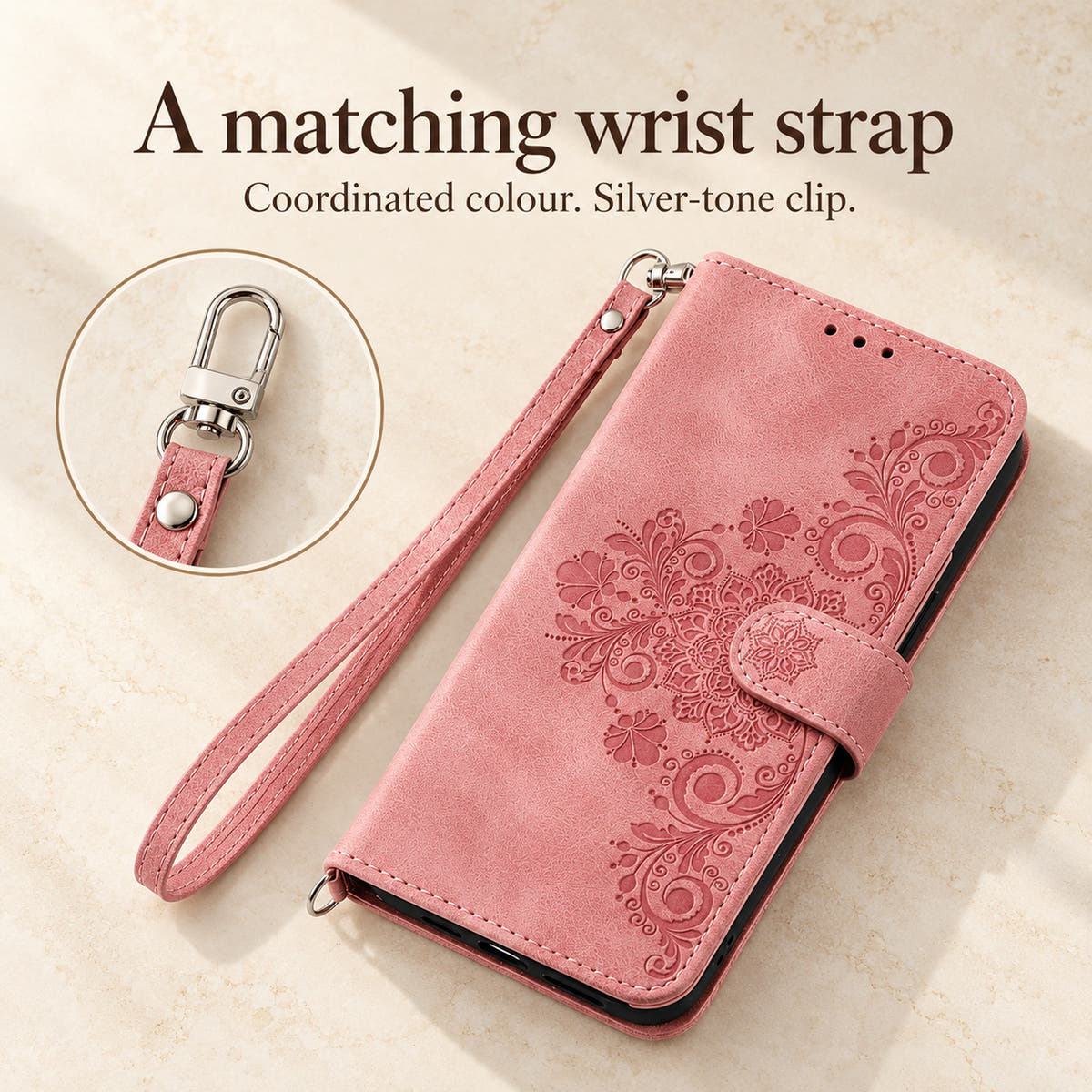 Pink floral flip wallet case and matching wrist strap with silver-tone clip shown in a detail feature image