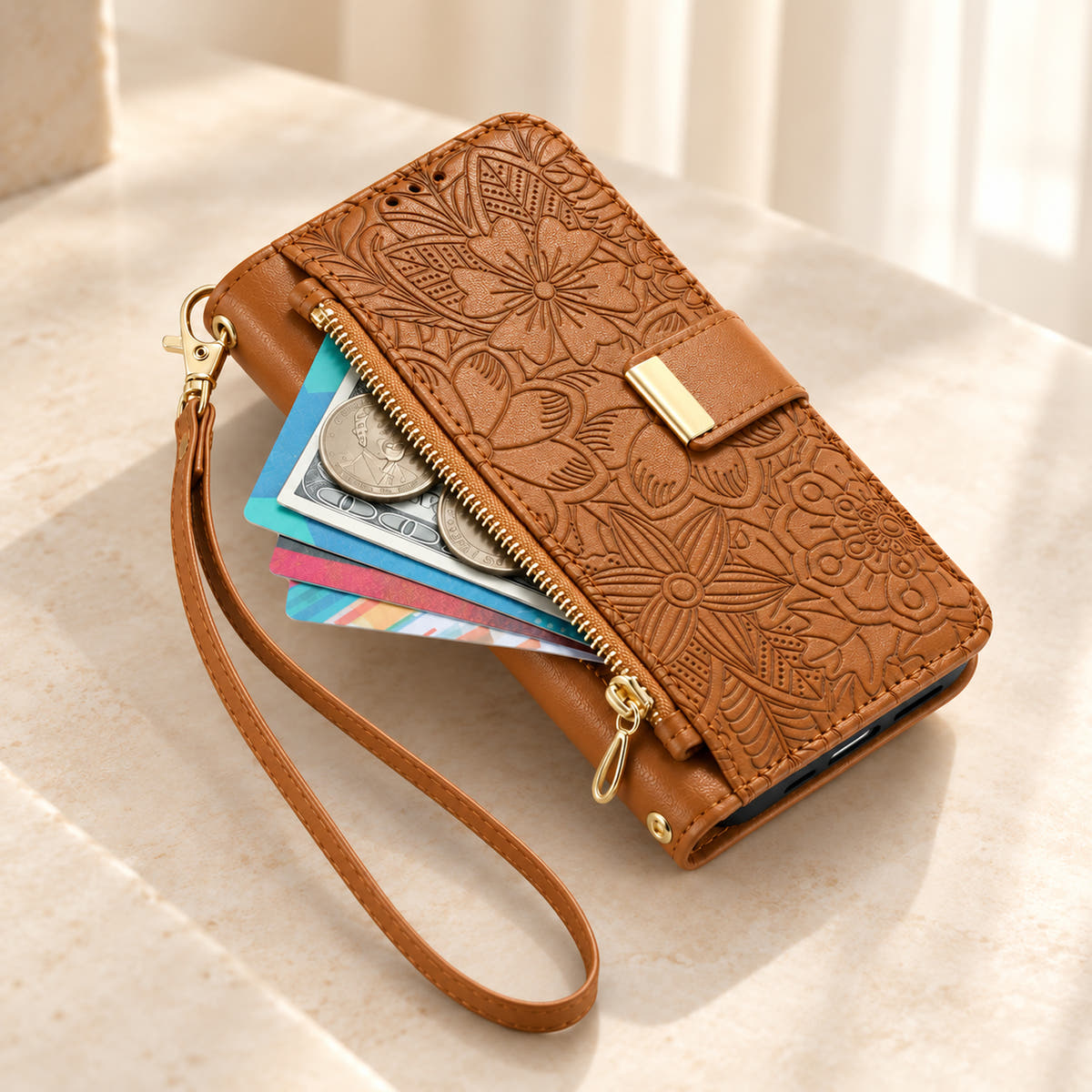 Brown floral iPhone wallet case with the front zip pouch open, showing space for small essentials and the matching wrist strap