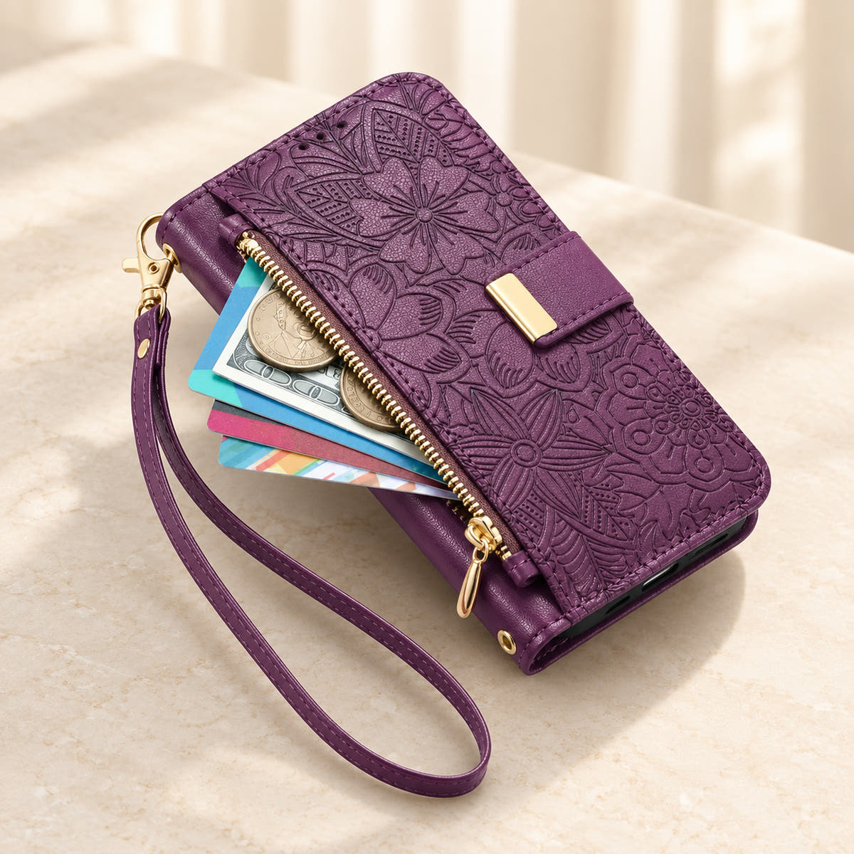 Purple floral iPhone wallet case with the front zip pouch open, showing space for small essentials and the matching wrist strap