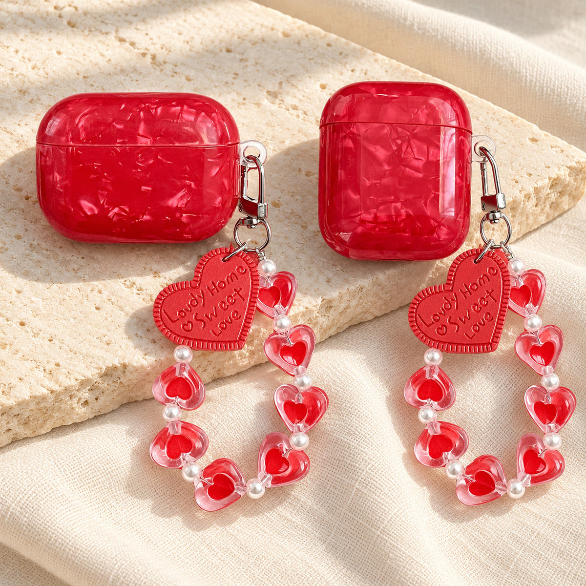 Garnet Marble AirPods case — wide tall pair with glossy red finish and heart-bead charm strap