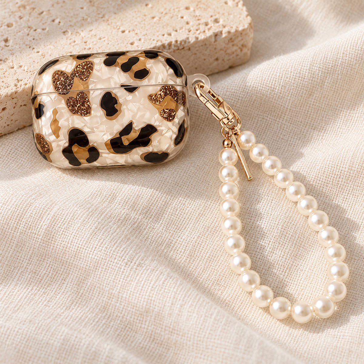 Gilded Leopard Heart AirPods case Design #1 — loop detail showing its pearl-style wrist loop