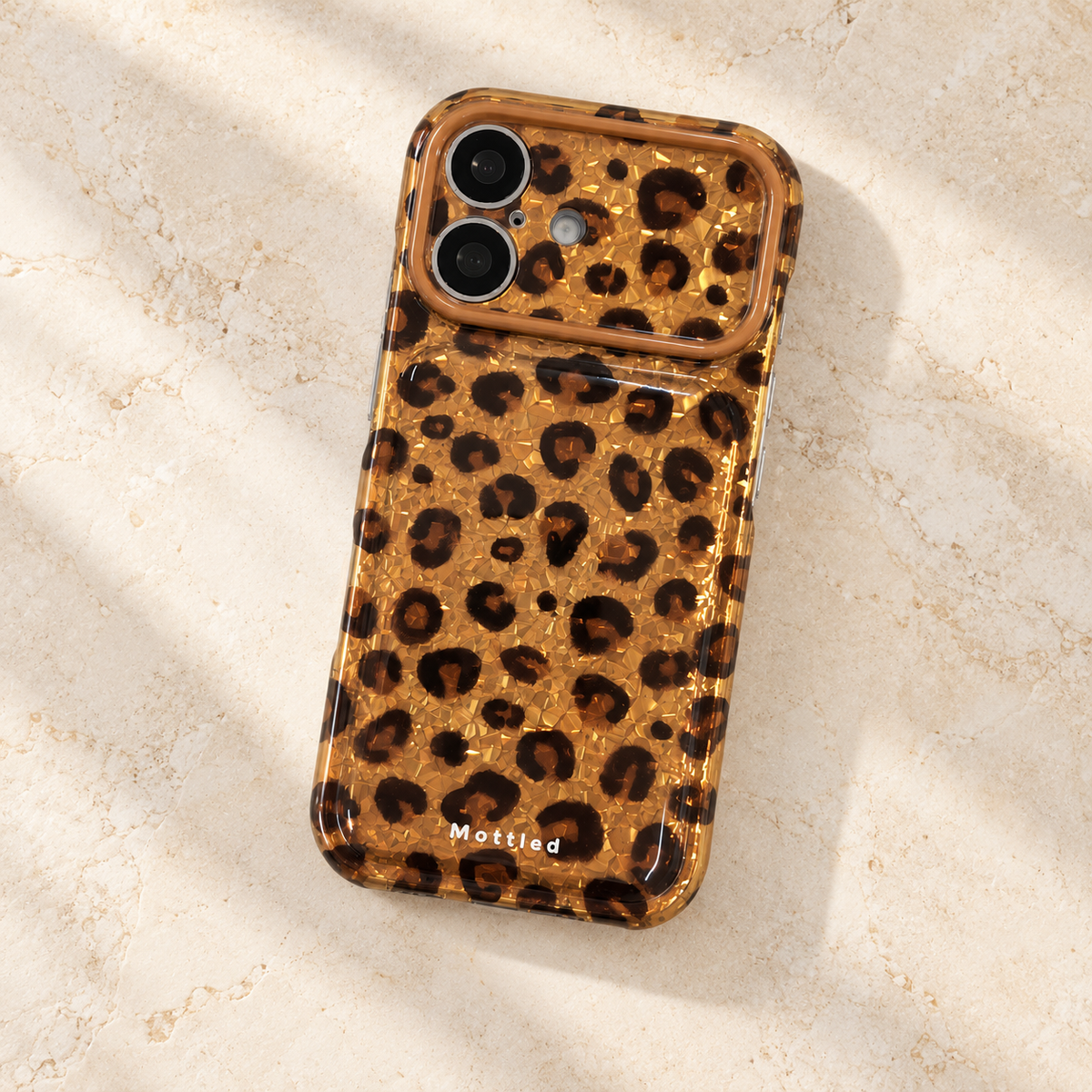 Glitter Leopard iPhone Case in Gold — diagonal rear flatlay