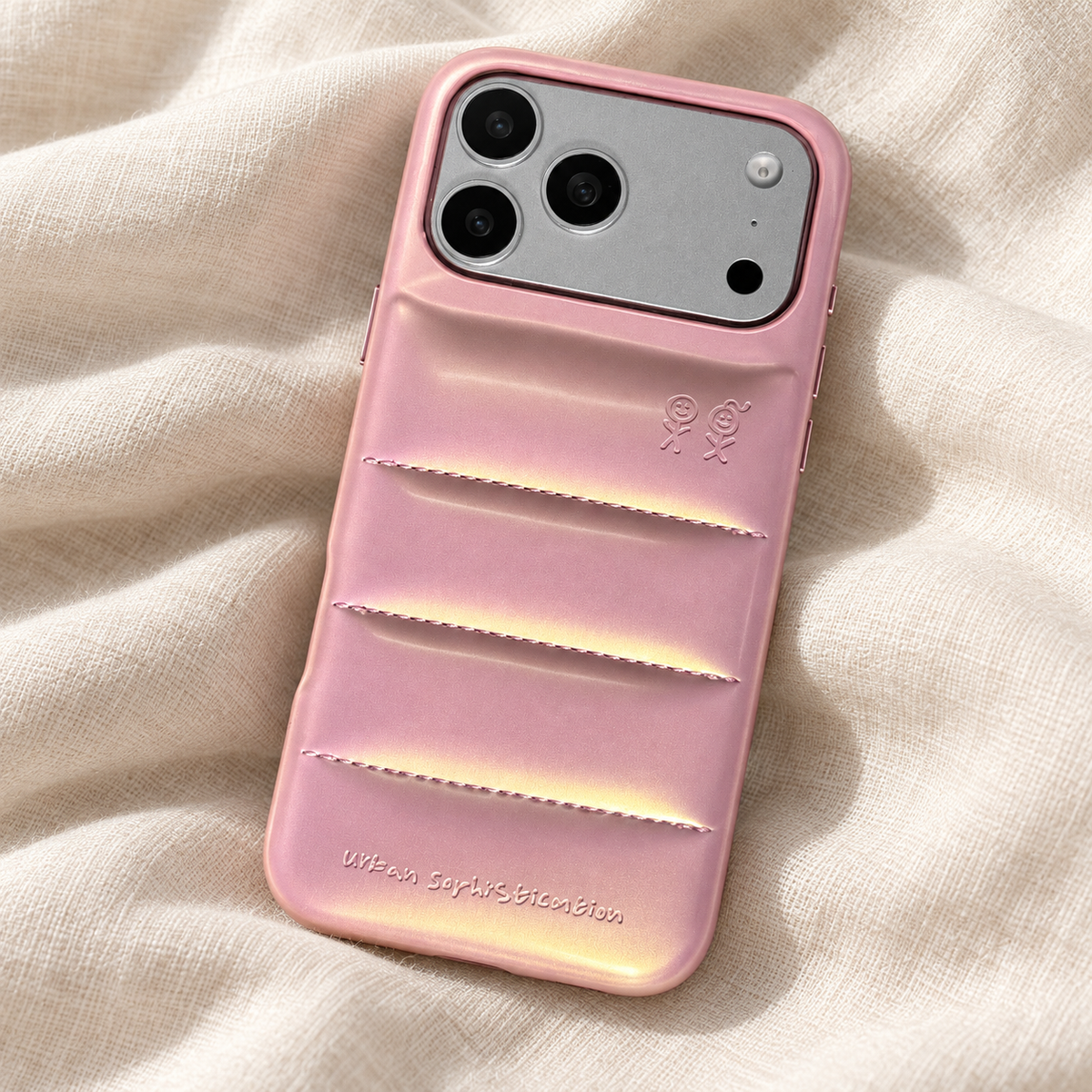 Rear view of the Iridescent Pink puffer case on gently folded cream linen.