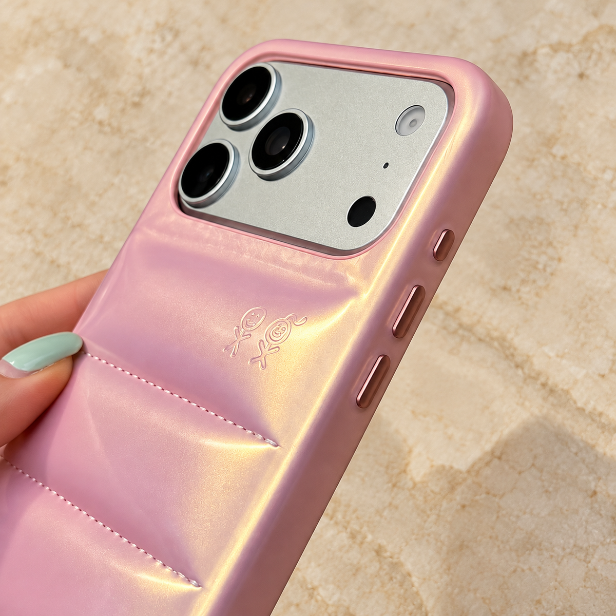 Close view of the camera rim, embossed figures and side openings on the Iridescent Pink case.