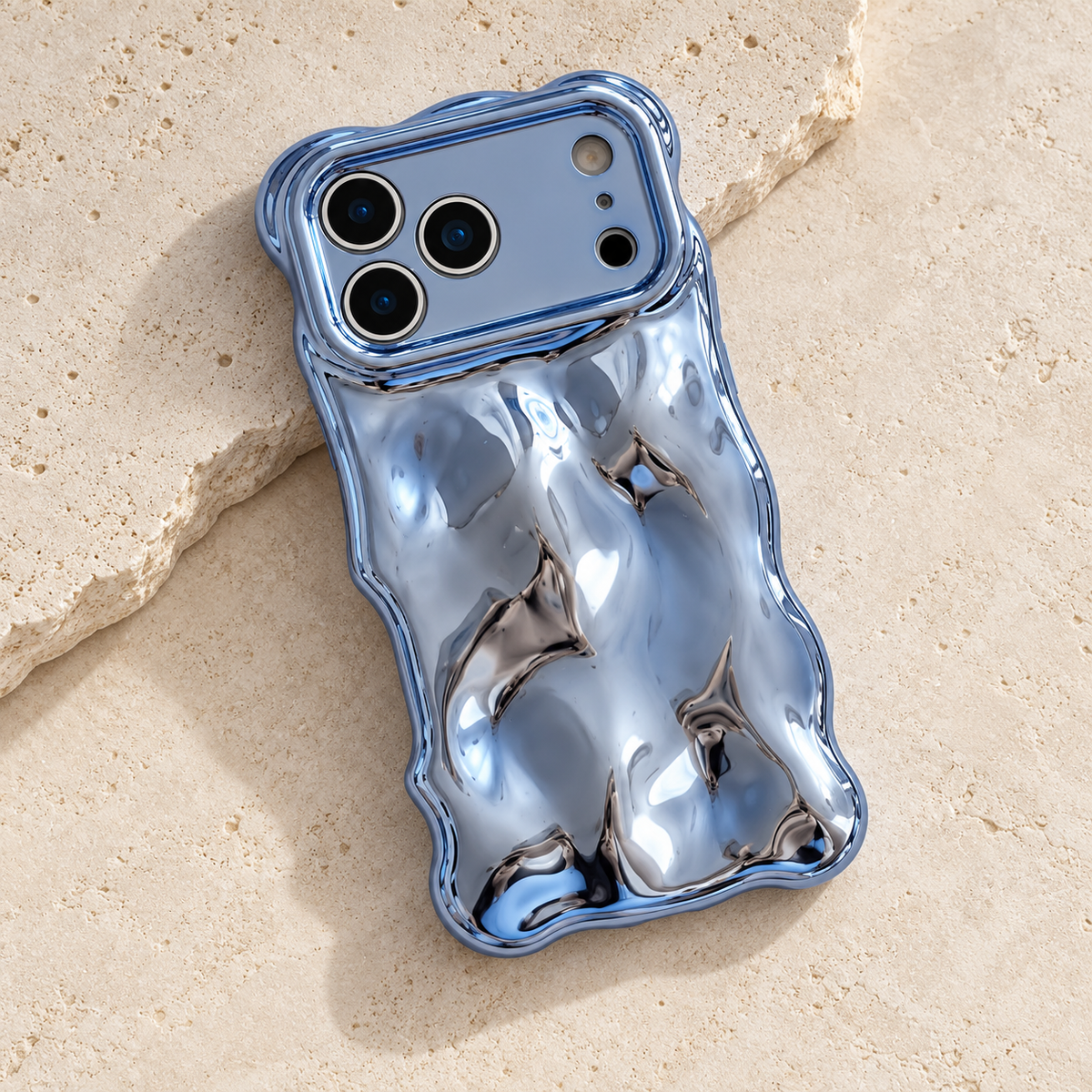 Diagonal flat-lay of the Blue Liquid Chrome Wave case showing its wavy outline.