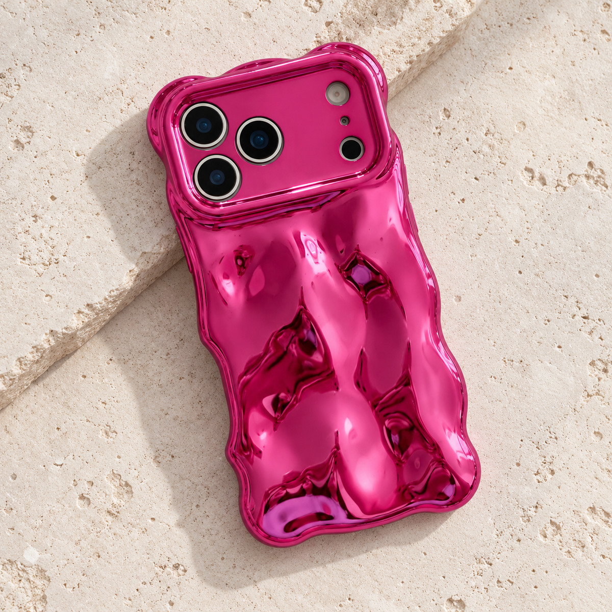 Diagonal flat-lay of the Hot Pink Liquid Chrome Wave case showing its wavy outline.
