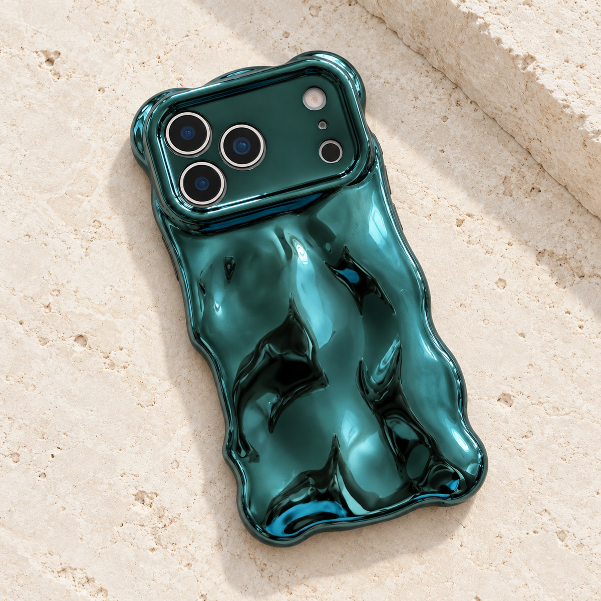 Diagonal flat-lay of the Teal Liquid Chrome Wave case showing its wavy outline.