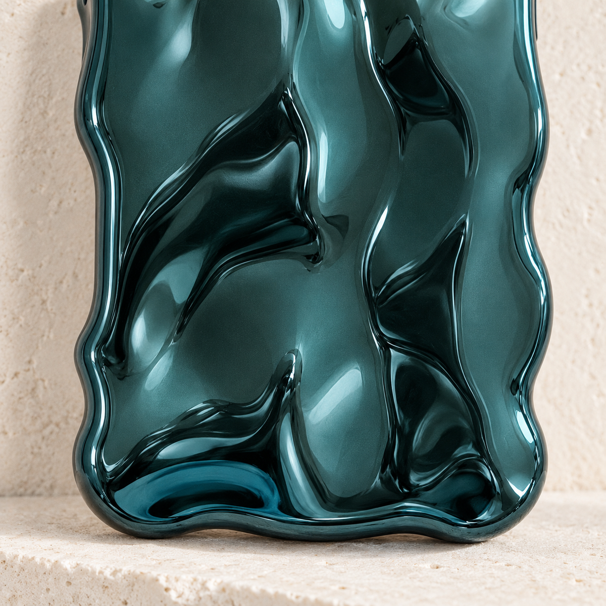 Close-up of the Teal Liquid Chrome Wave case's rippled finish and lower curved edge.