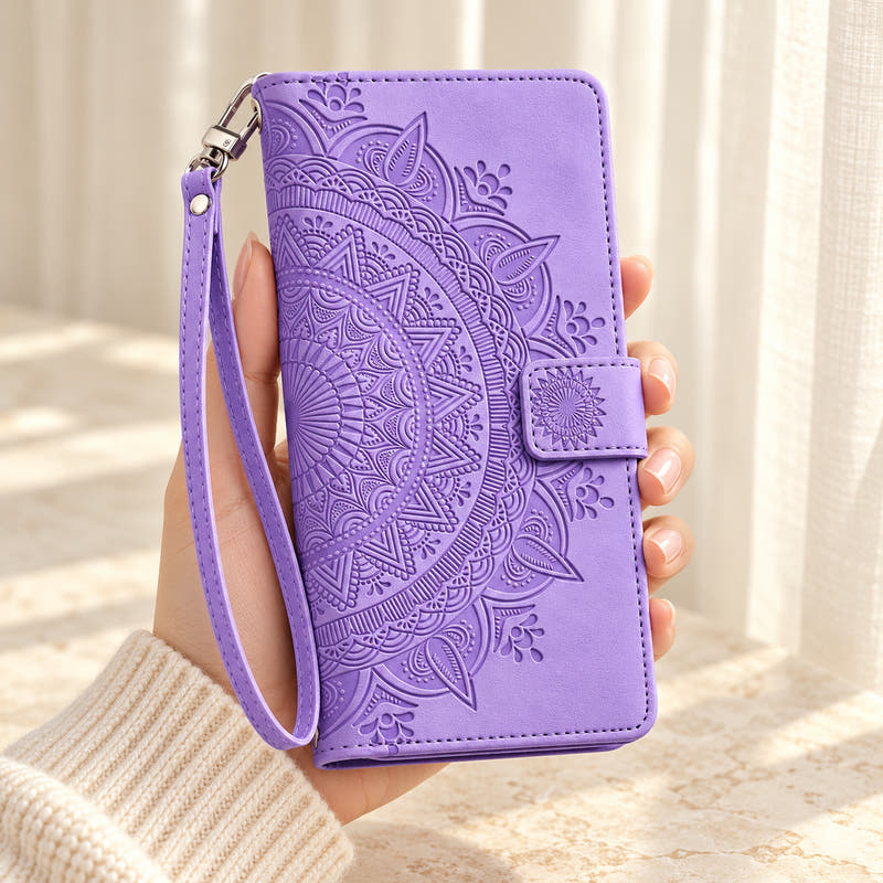 Lotus Mandala iPhone wallet case in Lavender showing the embossed front and wrist strap held in a cream-sleeve hand