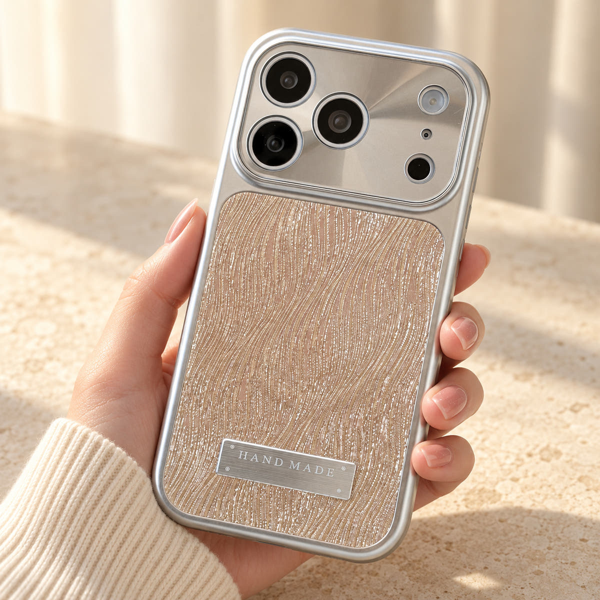Luna Belle textured shimmer iPhone case in Beige, shown at a rear three-quarter angle.