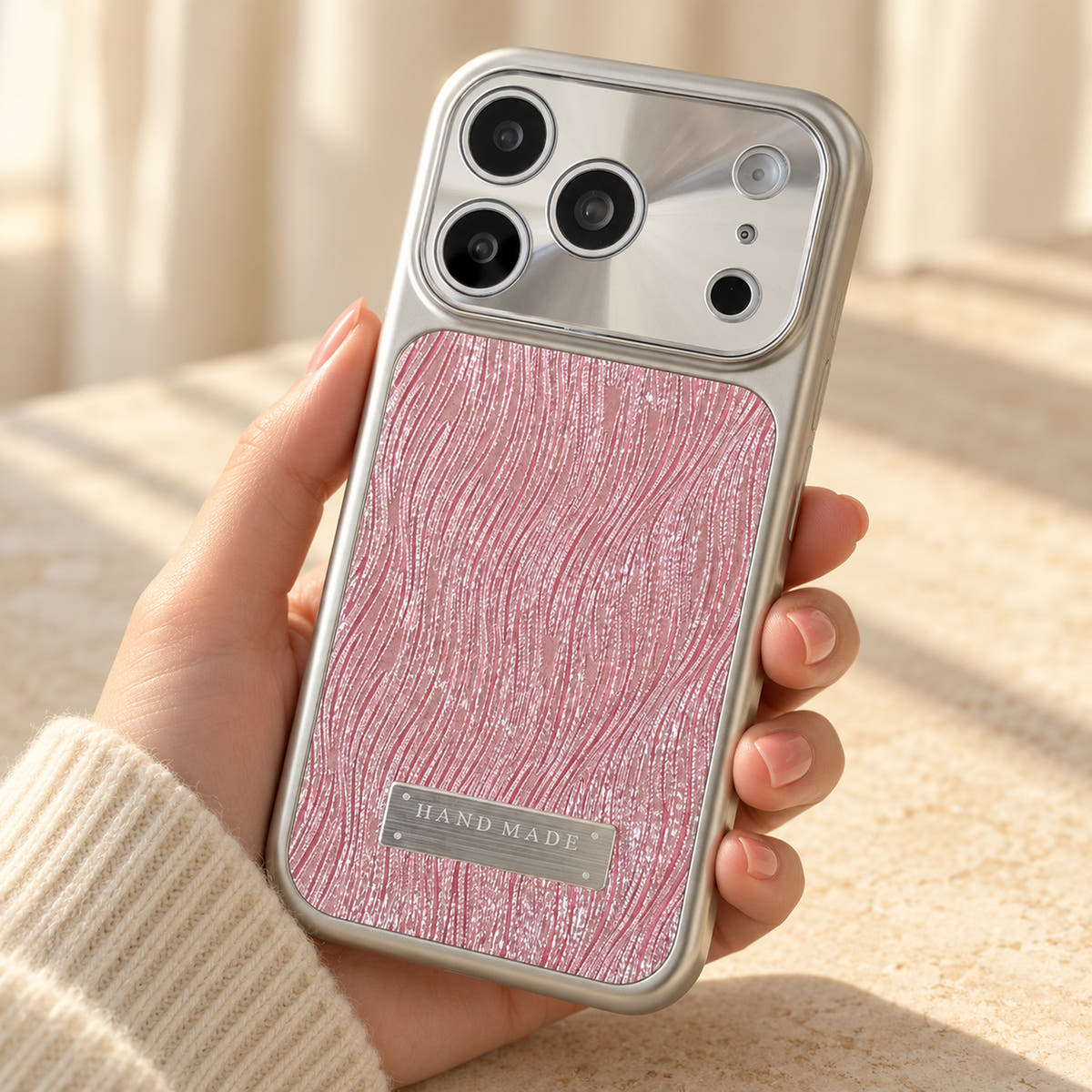 Luna Belle textured shimmer iPhone case in Pink, shown at a rear three-quarter angle.
