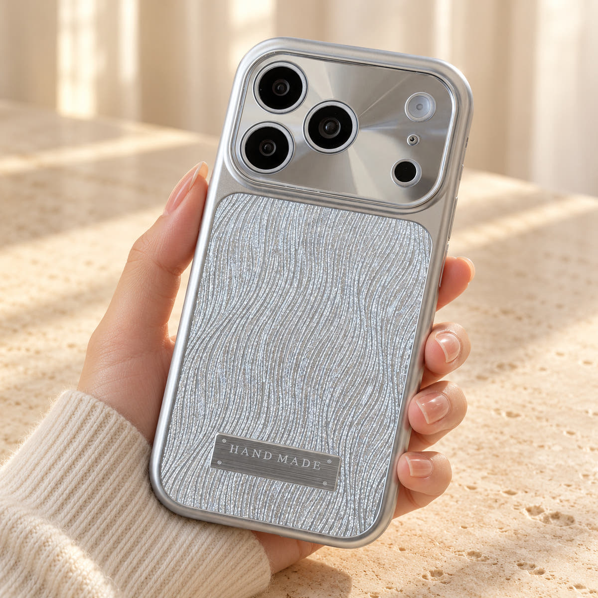 Luna Belle textured shimmer iPhone case in Silver, shown at a rear three-quarter angle.