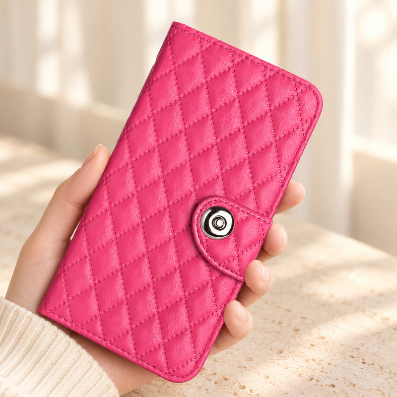 Luxe Quilted iPhone wallet case in Candy Pink, closed handheld view with diamond pattern and circular tab closure.