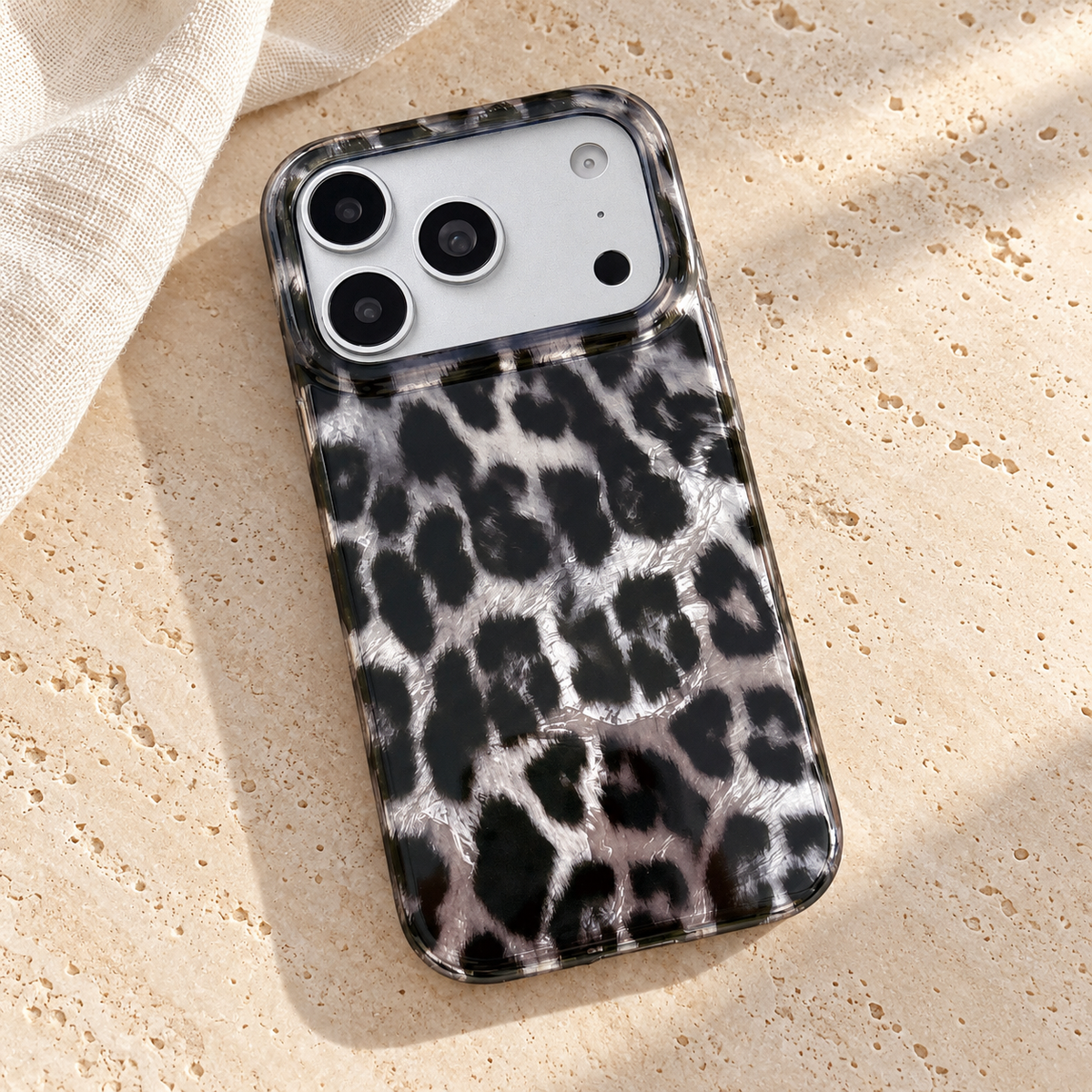 Angled rear view of the leopard print case on a pale travertine tabletop.