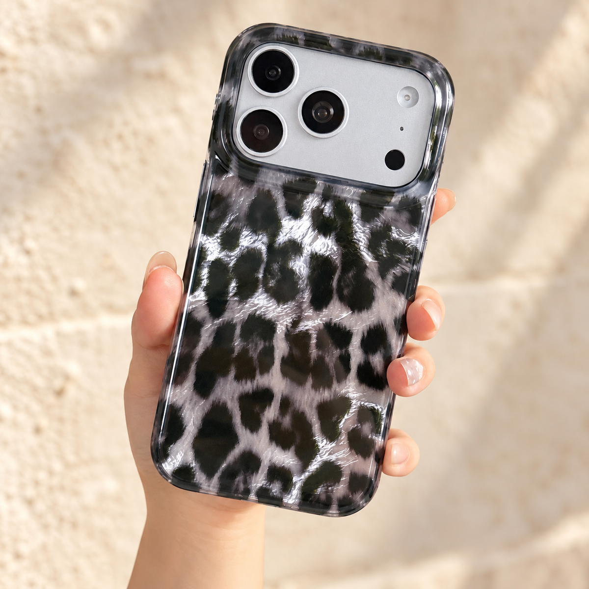 Closer handheld view showing the reflective silver leopard print and clear corners.