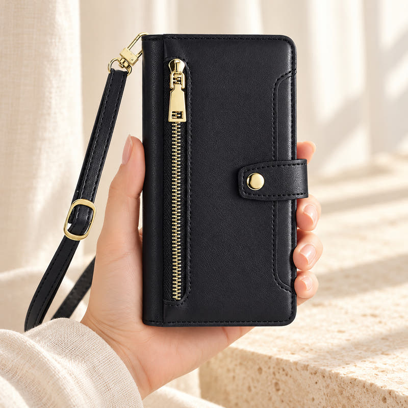 Minimal crossbody iPhone wallet case in Black — front held in hand showing gold-tone zip and closure tab