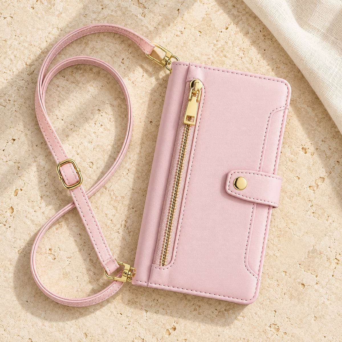 Minimal crossbody iPhone wallet case in Pink — overhead front view with matching adjustable shoulder strap