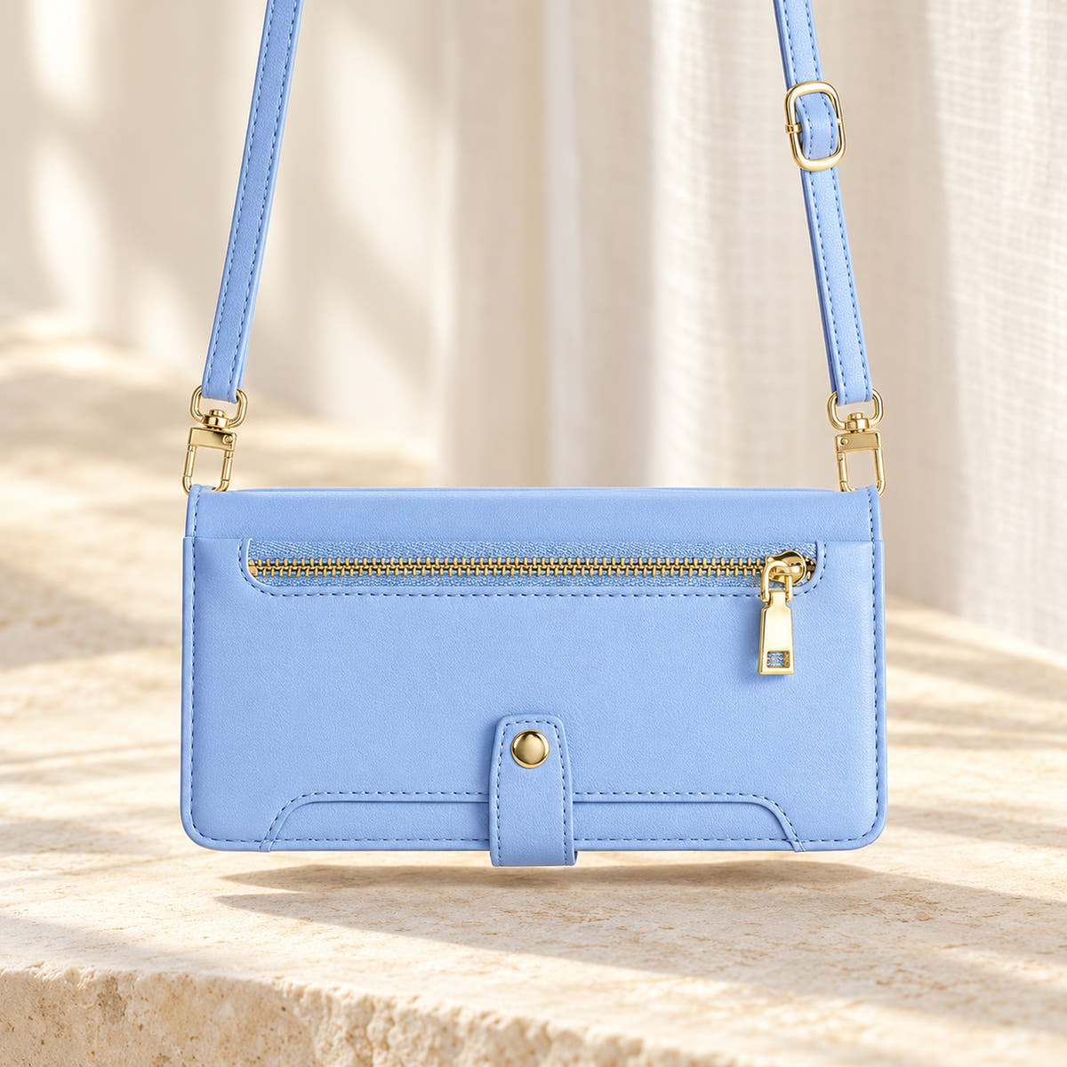 Minimal crossbody iPhone wallet case in Sky Blue — landscape view with long matching shoulder strap and gold-tone clips