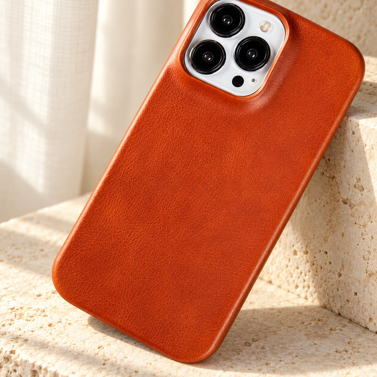 Minimal leather-look iPhone case in Light Brown, close-up of the fine-grained back and rounded corners.