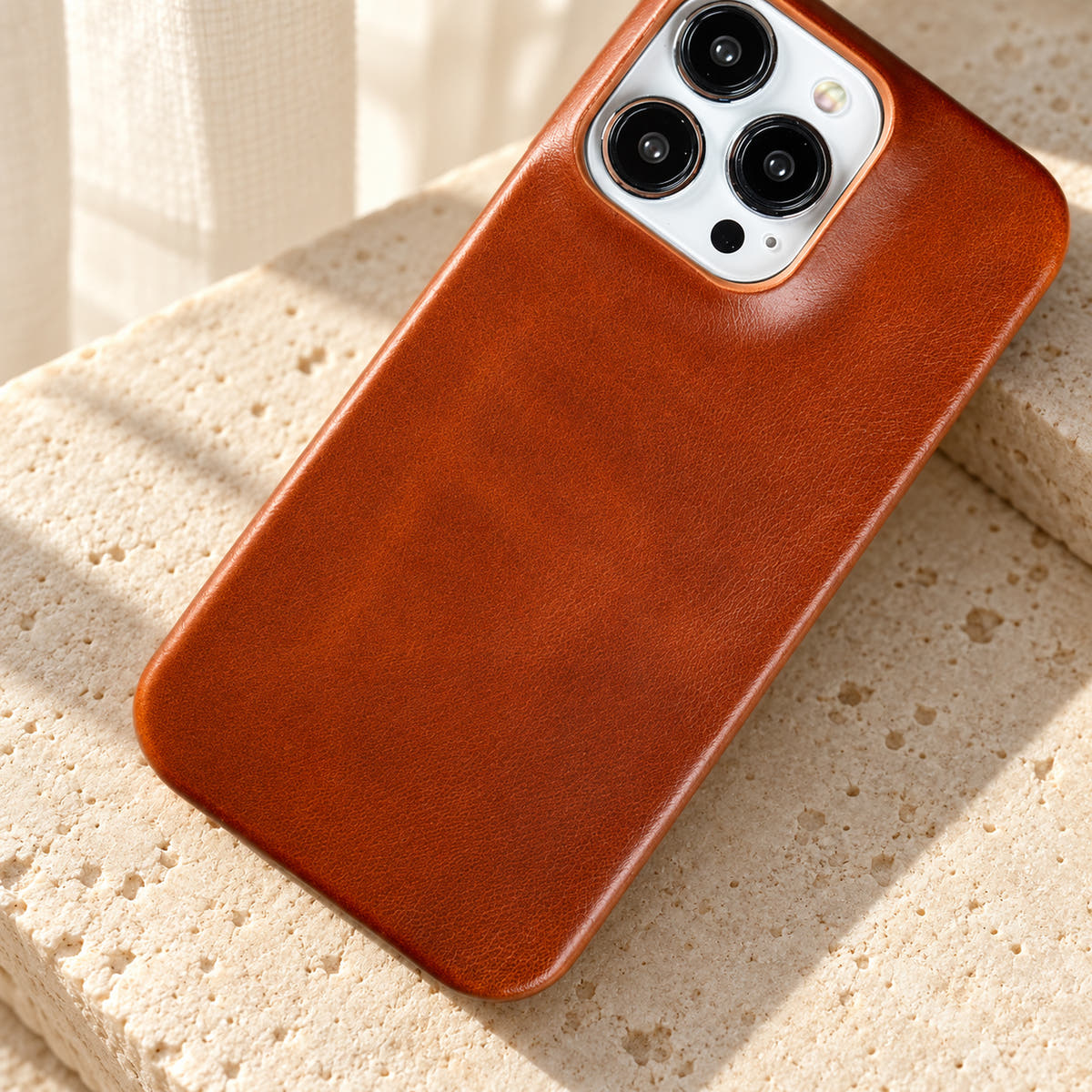 Minimal leather-look iPhone case in Orange Red, close-up of the fine-grained back and rounded corners.
