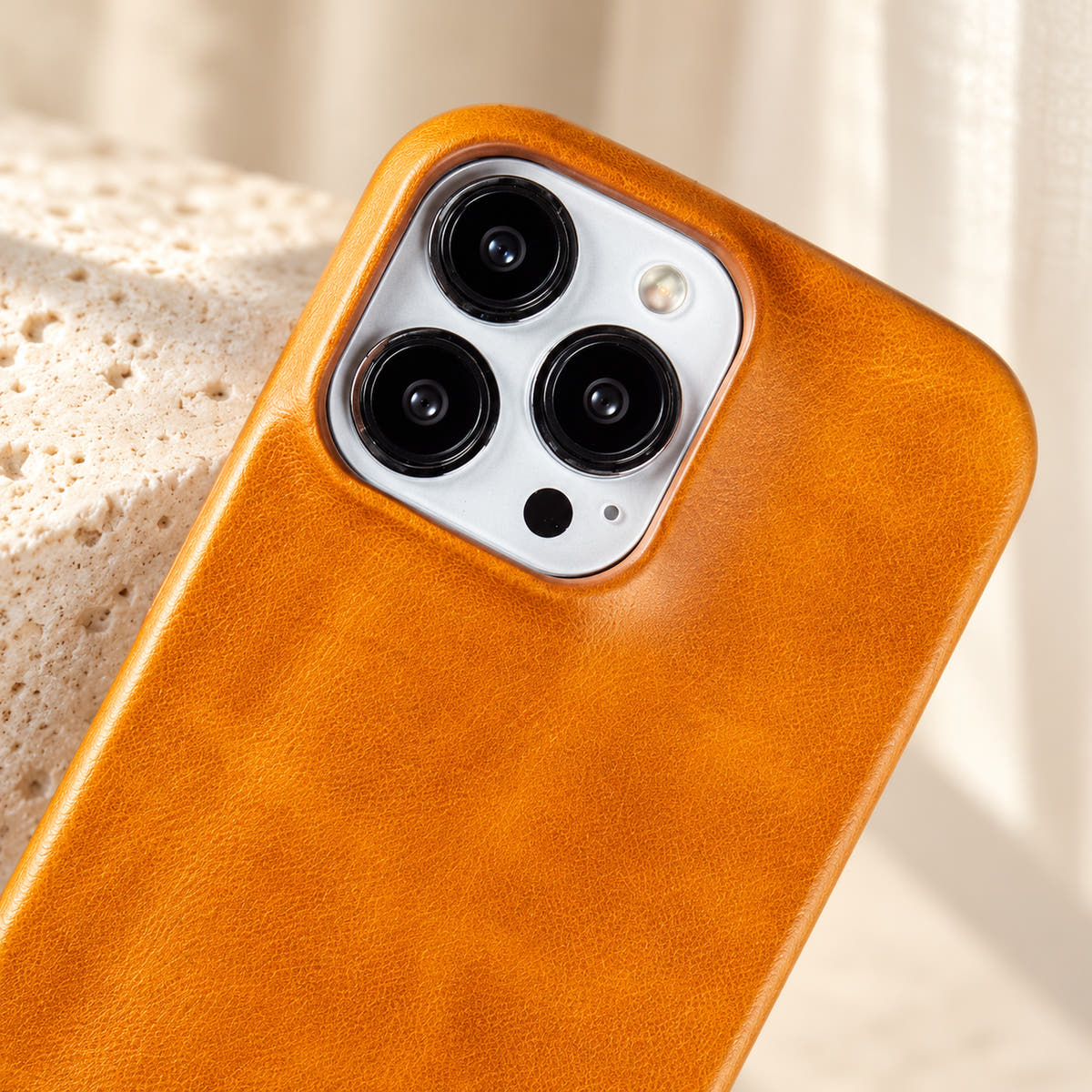 Minimal leather-look iPhone case in Yellow, close-up of the matching camera border.