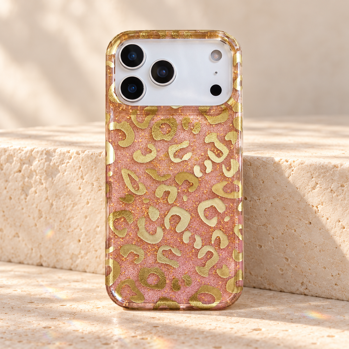 Full rear view of the Pink & Gold case standing against a cream stone block.
