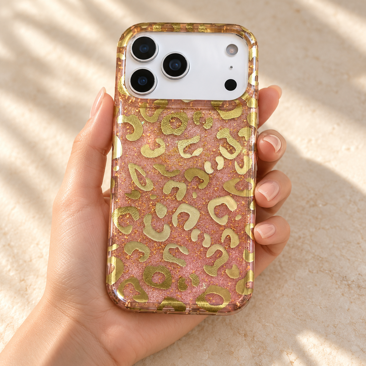 Golden Blush Leopard case held upright in one hand with the complete Pink & Gold pattern visible.