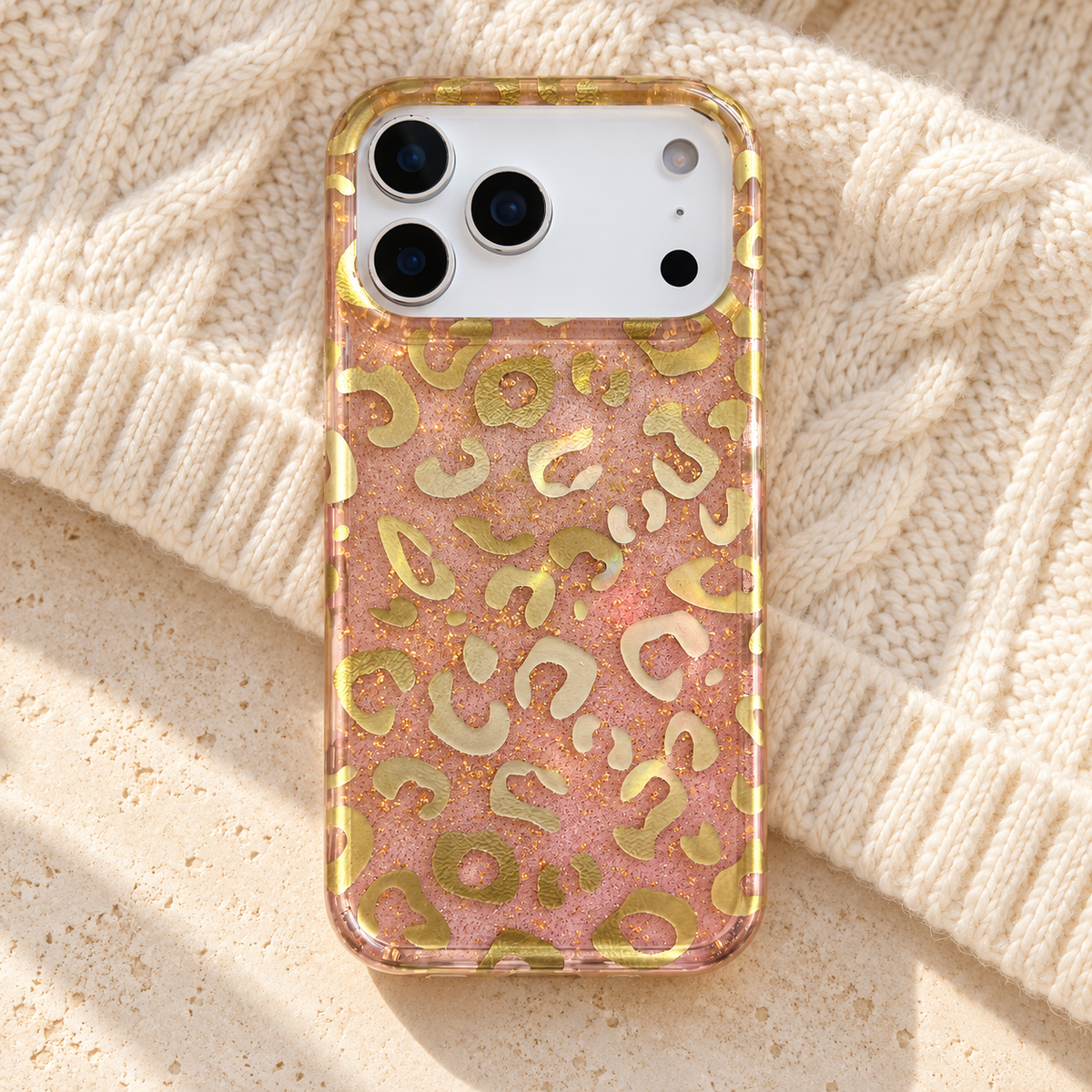 Golden Blush Leopard case resting on ivory knit fabric.
