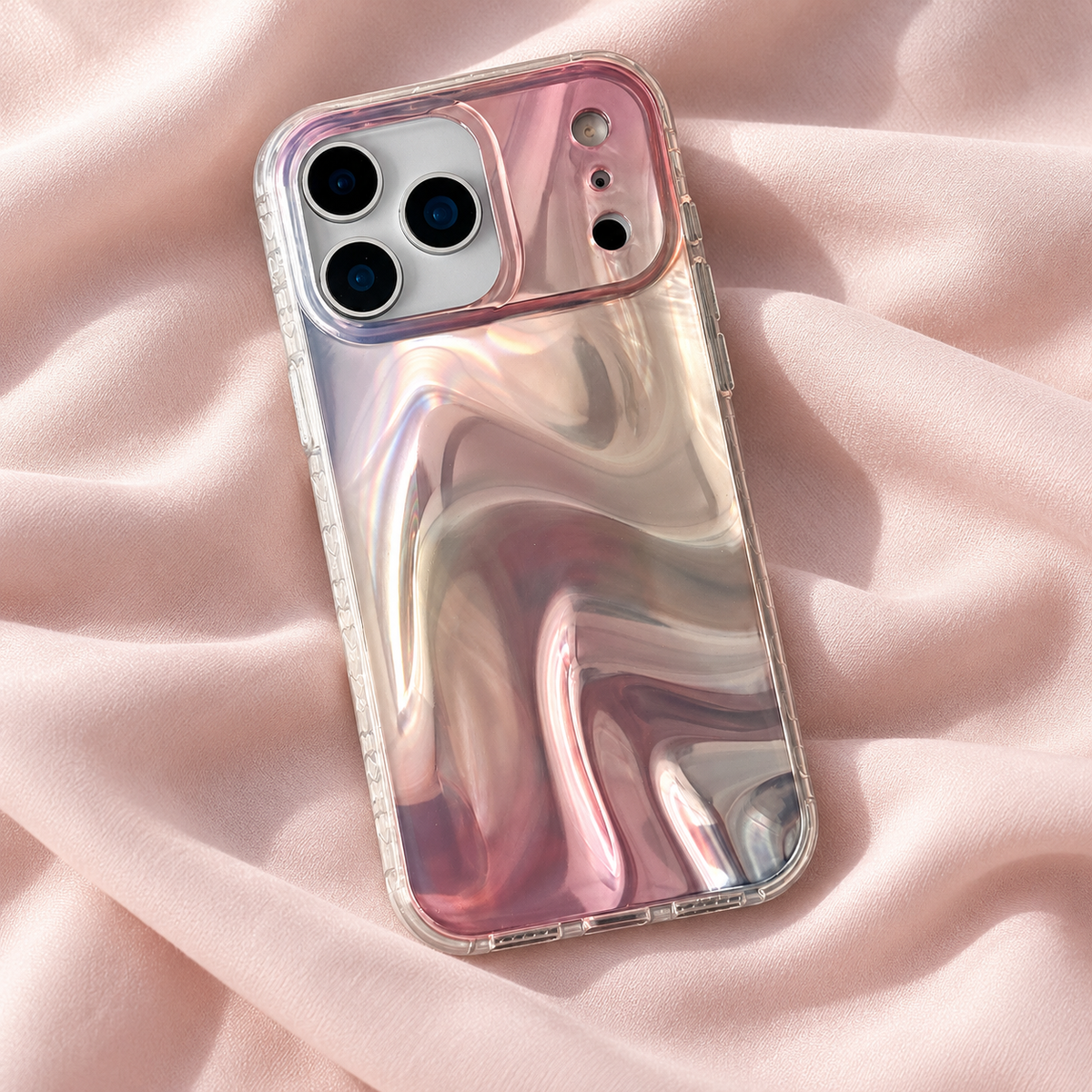 Iridescent Rose case lying diagonally on softly folded pale blush fabric.