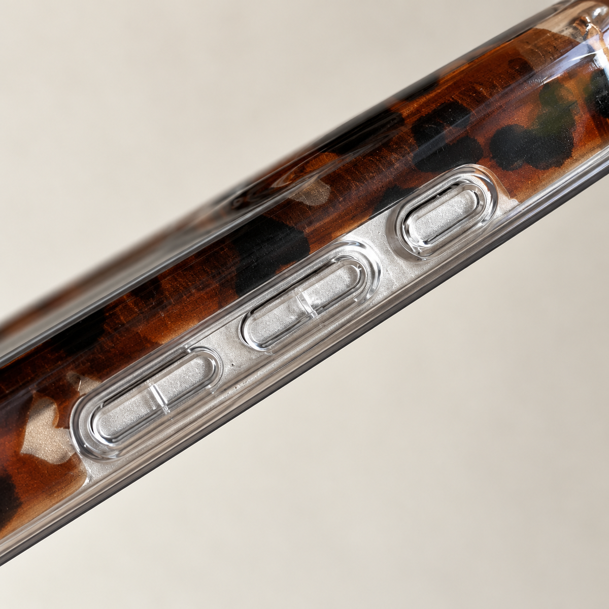 Close-up of the Amber Leopard Heart case’s clear side and three button covers.
