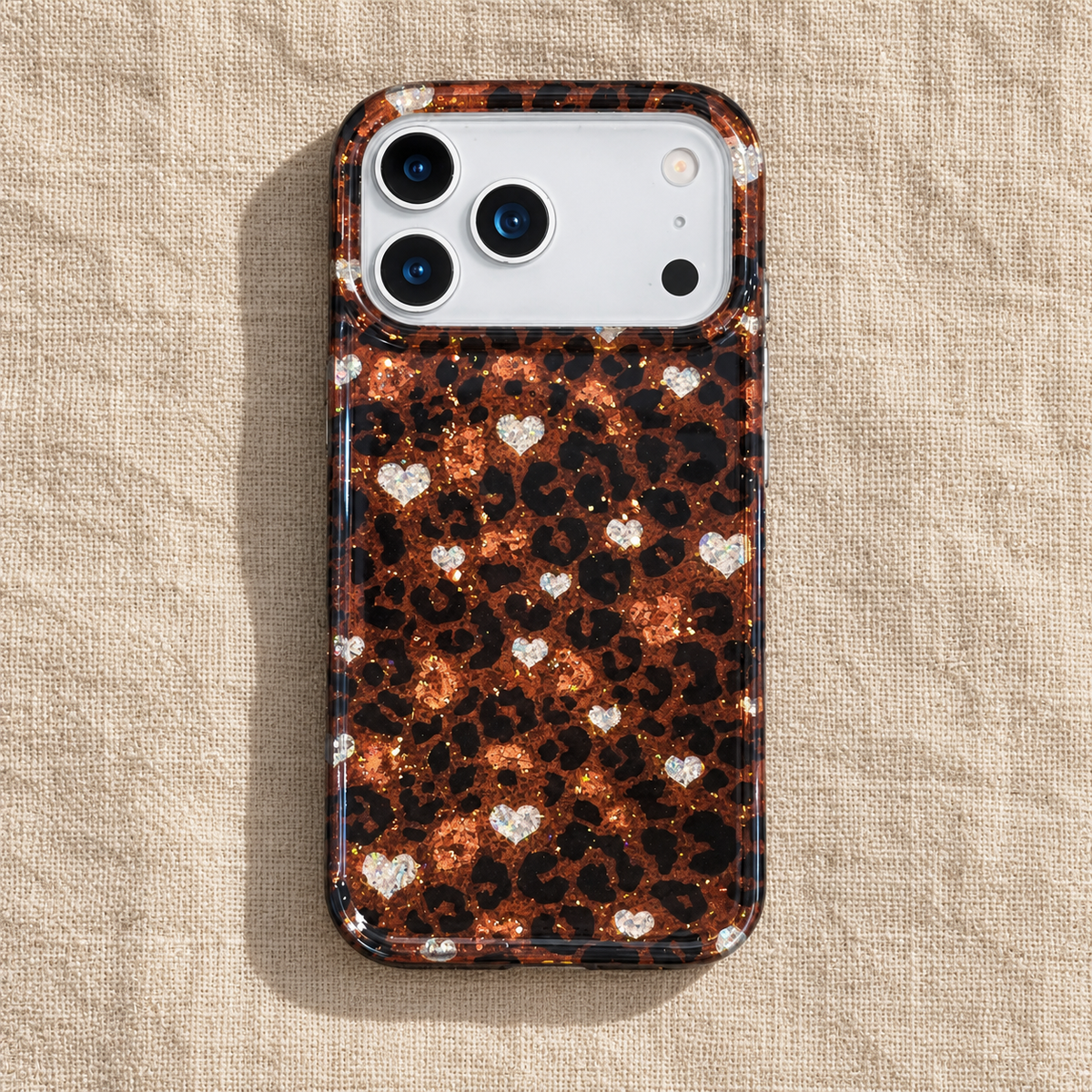 Amber Leopard Heart case photographed from above on natural linen.