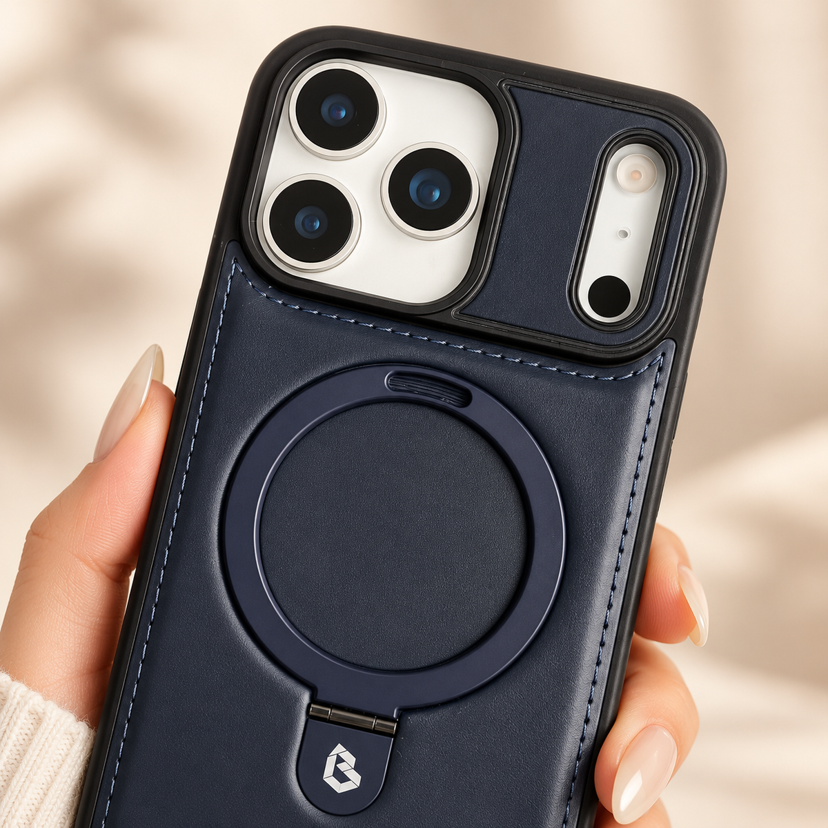 Navy stitched ring-stand iPhone case in a close view of its native camera surround and rear finish.