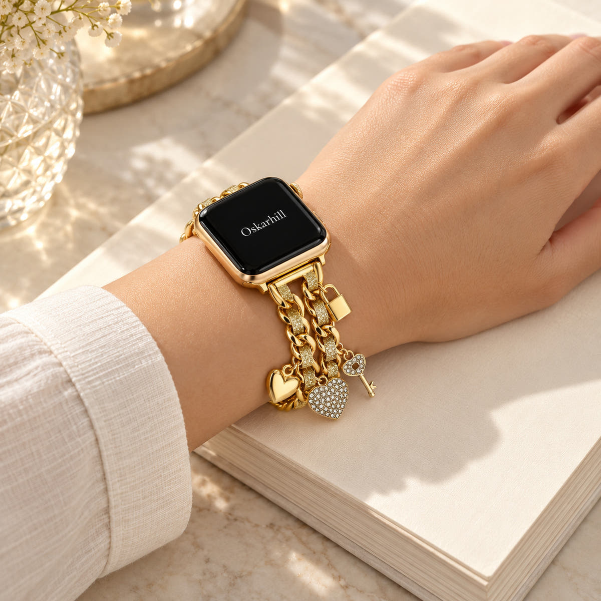Oskar Hill Amorette Apple Watch charm band — relaxed feminine hand with the charm band clearly visible